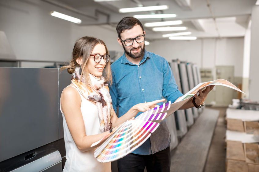 Woman with print operator at the manufacturing